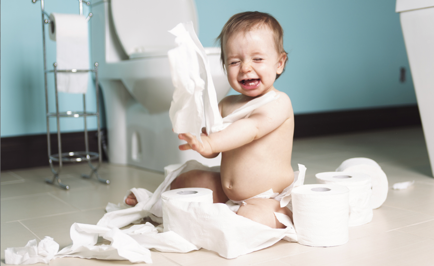 Baby playing with toilet paper