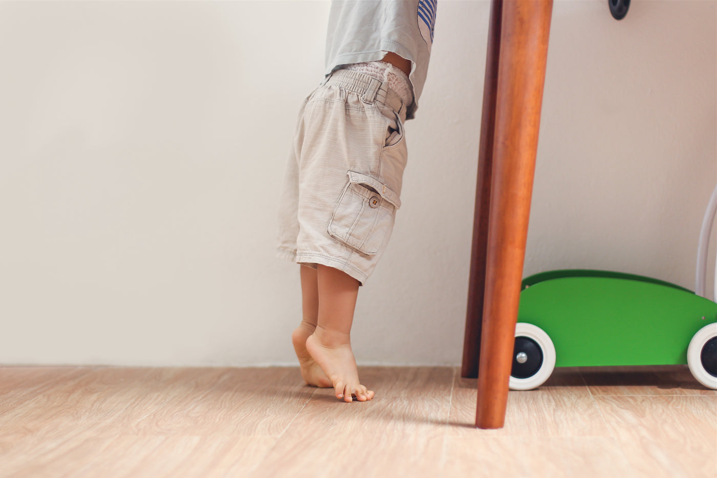 Toddler on his toes to reach for something